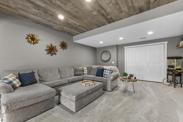 living area featuring carpet flooring, recessed lighting, and visible vents