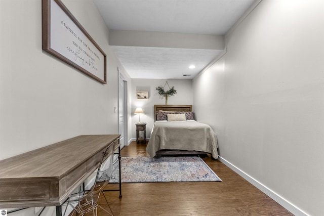 bedroom featuring baseboards, recessed lighting, and wood finished floors