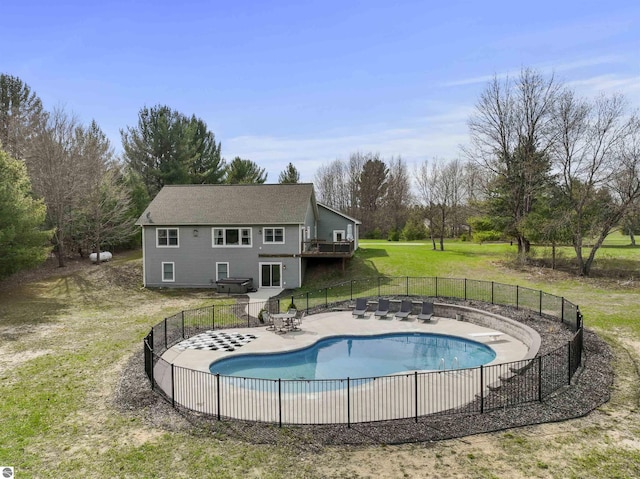 view of swimming pool with a lawn, fence, a fenced in pool, and a patio area