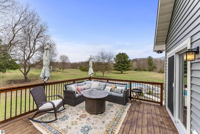 wooden terrace featuring a lawn and an outdoor hangout area