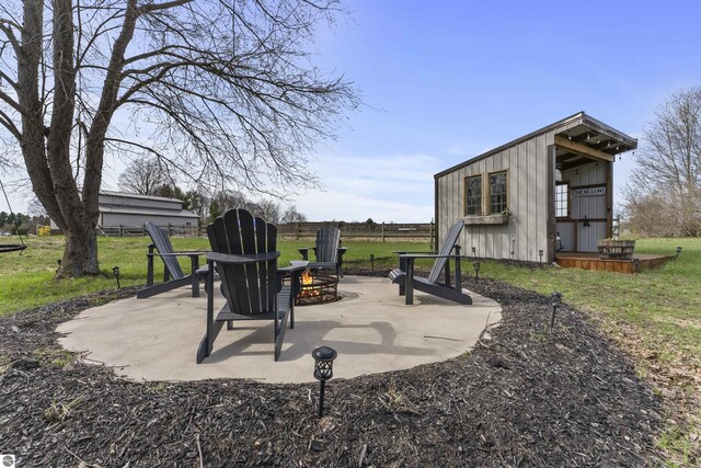 view of patio / terrace featuring an outdoor structure and an outdoor fire pit