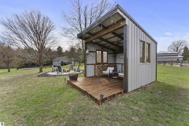 view of outbuilding featuring fence and an outbuilding