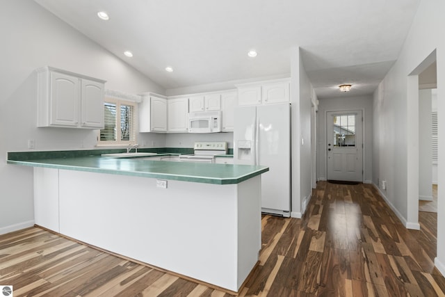 1316 Terra Rd, Traverse City, MI 49686 - kitchen with dark wood-style flooring, white cabinetry, a peninsula, and white appliances