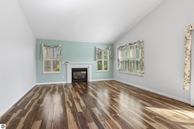 1316 Terra Rd, Traverse City, MI 49686 - unfurnished living room with wood-type flooring, a fireplace, a wealth of natural light, and vaulted ceiling