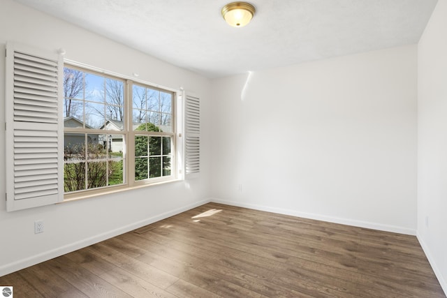 1316 Terra Rd, Traverse City, MI 49686 - unfurnished room with baseboards and wood finished floors