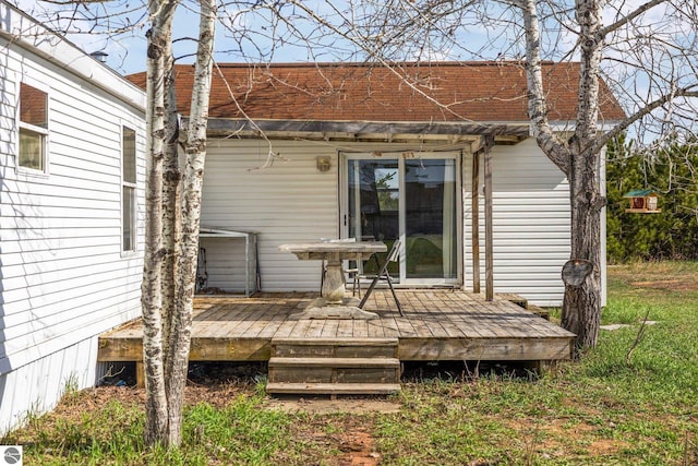 rear view of property featuring a deck