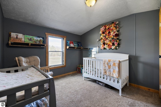 carpeted bedroom with baseboards, a textured ceiling, and lofted ceiling