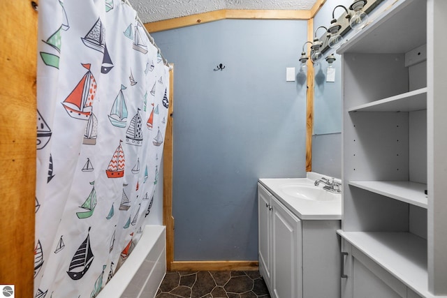 full bathroom featuring vanity, shower / bath combo with shower curtain, and tile patterned floors