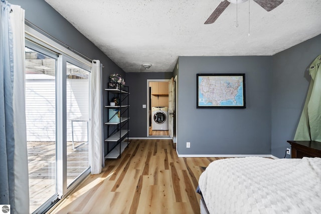 bedroom with baseboards, ceiling fan, a textured ceiling, washing machine and clothes dryer, and light wood-style flooring