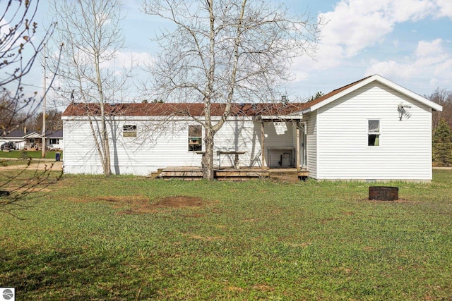 back of property with a yard