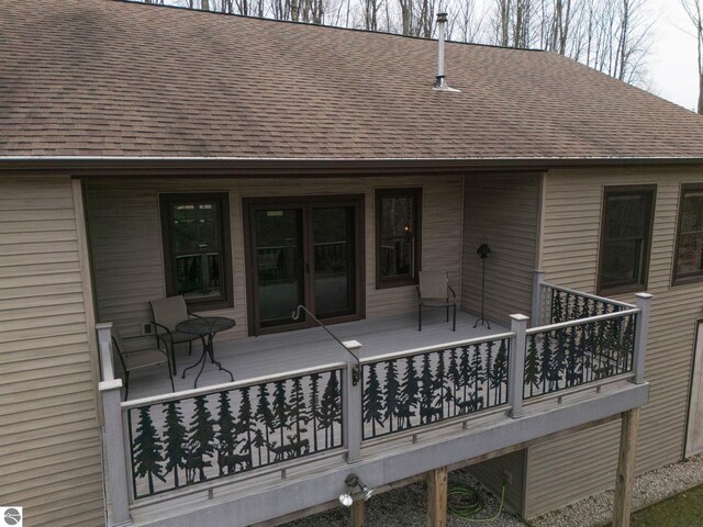 back of property with a shingled roof