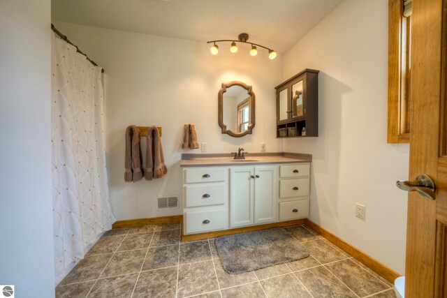 full bathroom with baseboards, visible vents, tile patterned floors, and vanity
