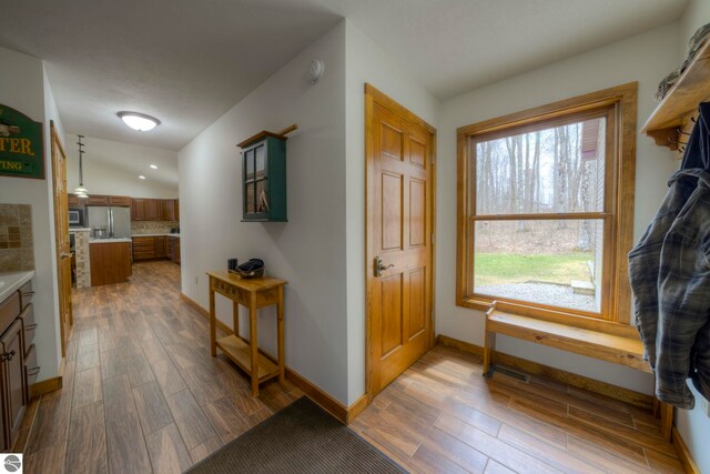foyer entrance featuring recessed lighting, baseboards, dark wood finished floors, and visible vents