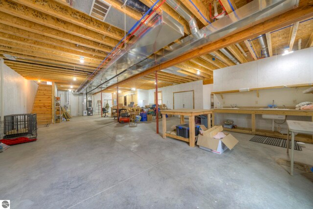 unfinished below grade area featuring a workshop area and stairway