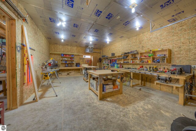 interior space with a workshop area and unfinished concrete floors