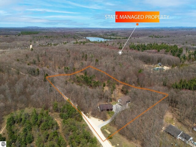 birds eye view of property with a view of trees