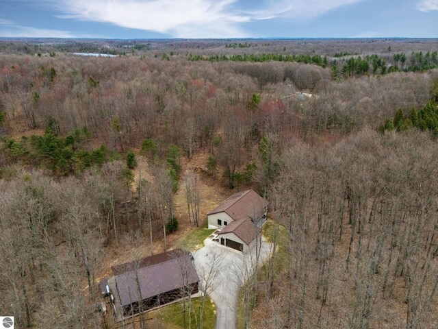 birds eye view of property featuring a view of trees