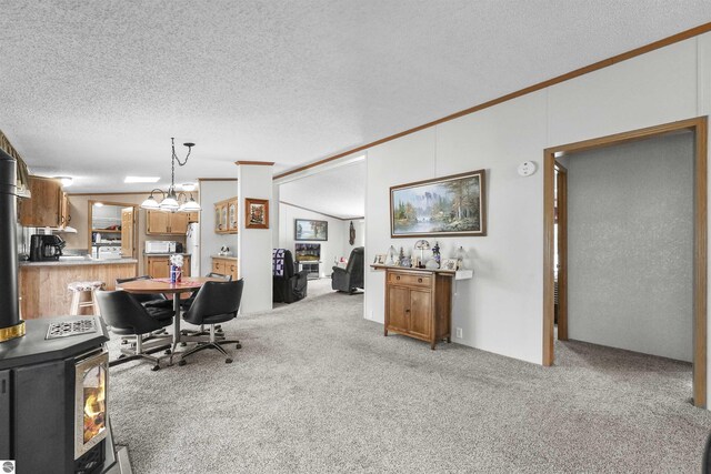 office area with light colored carpet, ornamental molding, a textured ceiling, and lofted ceiling