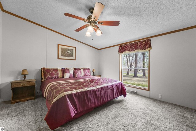 carpeted bedroom featuring visible vents, ornamental molding, a textured ceiling, and lofted ceiling