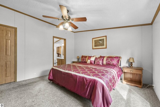 carpeted bedroom with connected bathroom, a textured ceiling, ornamental molding, and ceiling fan