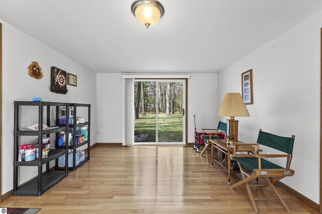 sitting room featuring light wood-type flooring and baseboards