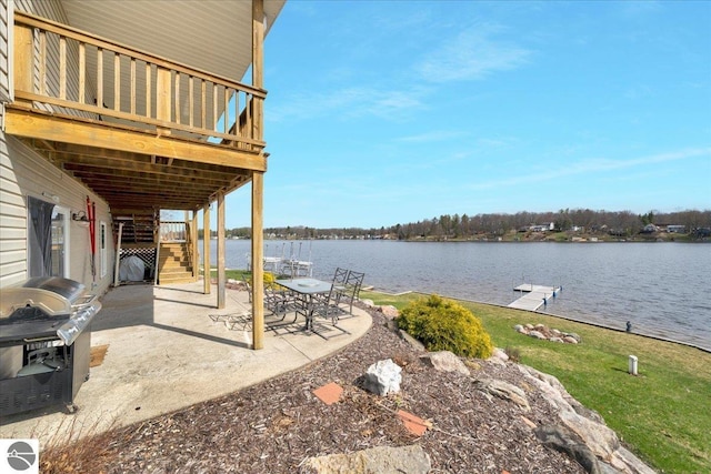 view of patio with a deck with water view, a boat dock, stairs, and area for grilling