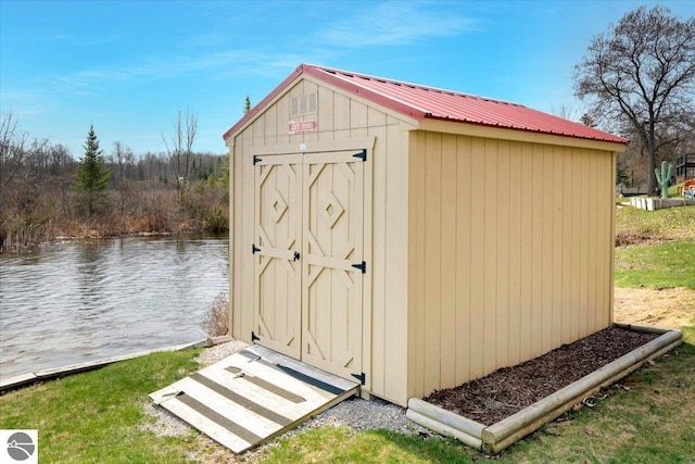 view of shed with a water view