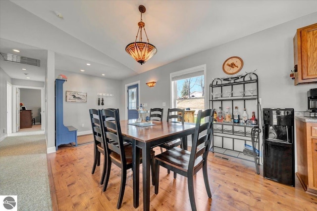 dining room with recessed lighting, visible vents, light wood finished floors, and lofted ceiling