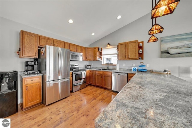 kitchen featuring brown cabinetry, open shelves, recessed lighting, light wood finished floors, and stainless steel appliances