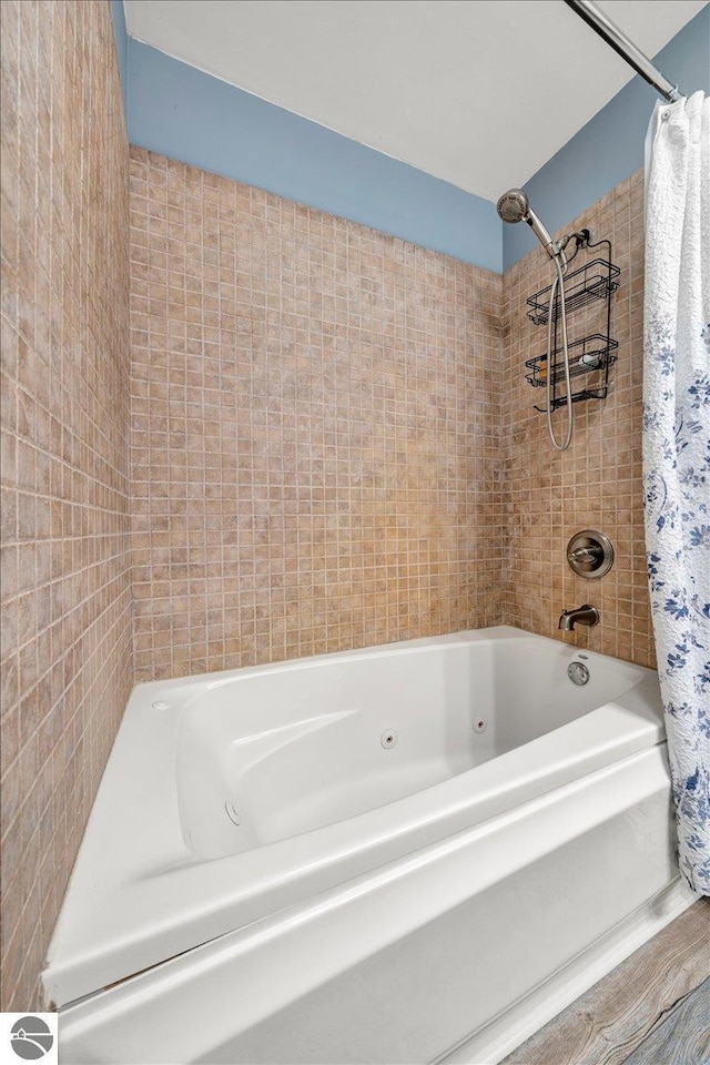 bathroom with shower / bath combo with shower curtain