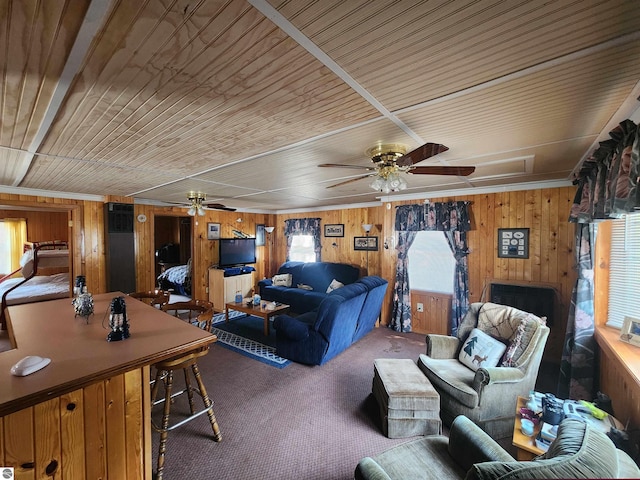 4320 Camp Rd, Oscoda, MI 48750 - living area featuring carpet floors, a ceiling fan, wood walls, and wood ceiling