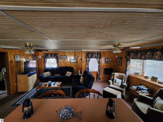 4320 Camp Rd, Oscoda, MI 48750 - carpeted living room with a ceiling fan and wood walls