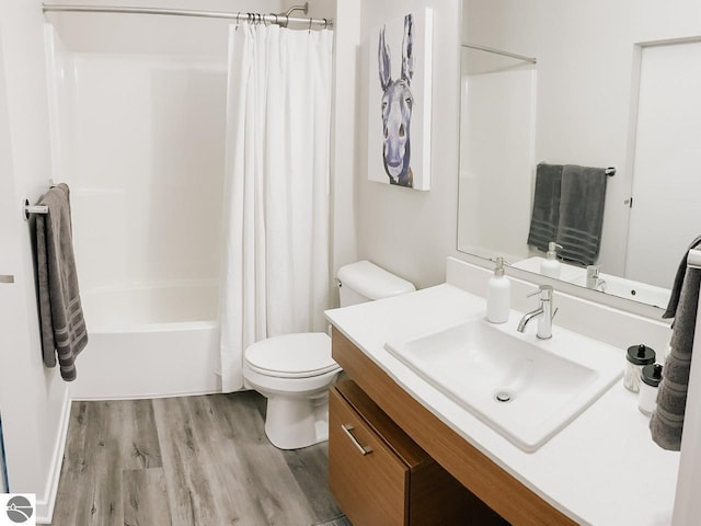 full bathroom with vanity, shower / tub combo, wood finished floors, and toilet