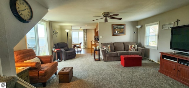 carpeted living room with a ceiling fan