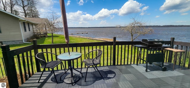 wooden terrace featuring a lawn, a water view, and area for grilling