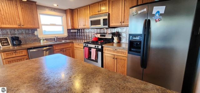 kitchen featuring recessed lighting, a sink, appliances with stainless steel finishes, and backsplash