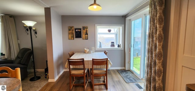 dining room with baseboards and wood finished floors