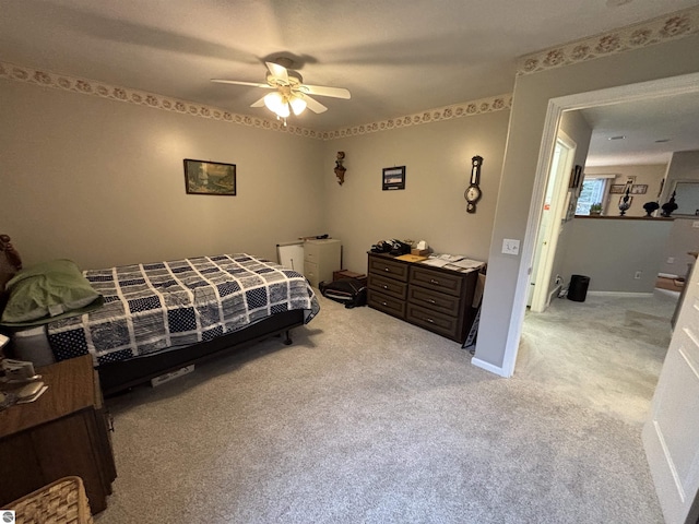 3633 Driftwood Dr, Cadillac, MI 49601 - bedroom featuring a ceiling fan, baseboards, and light carpet