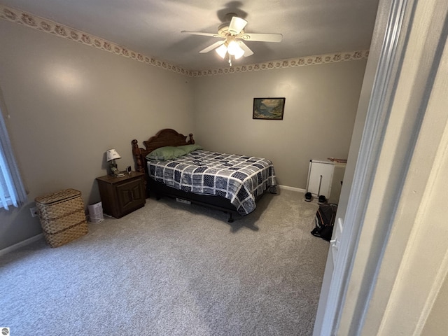 3633 Driftwood Dr, Cadillac, MI 49601 - carpeted bedroom with a ceiling fan and baseboards