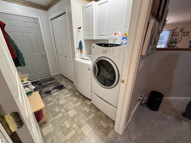 3633 Driftwood Dr, Cadillac, MI 49601 - laundry area featuring separate washer and dryer, cabinet space, baseboards, and brick patterned floor