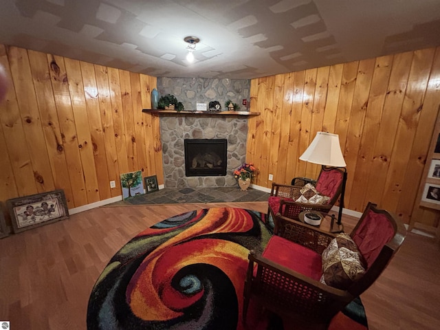 3633 Driftwood Dr, Cadillac, MI 49601 - living room with wood walls, a stone fireplace, and wood finished floors