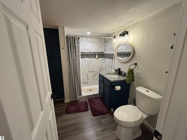 3633 Driftwood Dr, Cadillac, MI 49601 - full bathroom with vanity, toilet, recessed lighting, a shower stall, and wood finished floors