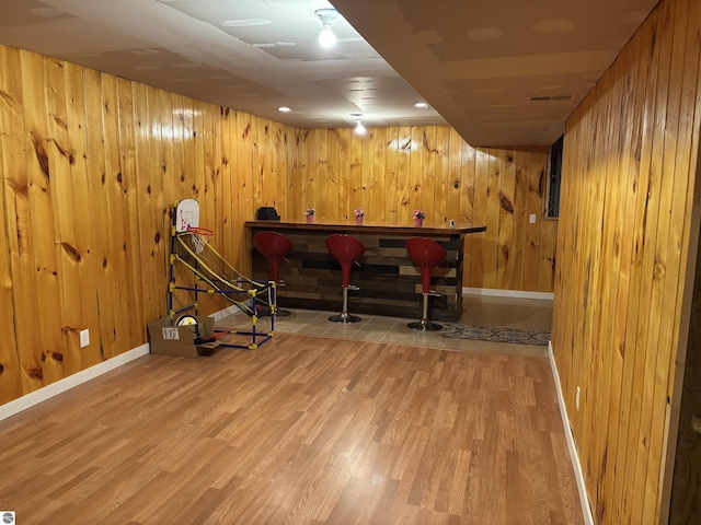 3633 Driftwood Dr, Cadillac, MI 49601 - finished below grade area featuring wooden walls, baseboards, and wood finished floors
