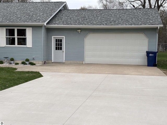 3633 Driftwood Dr, Cadillac, MI 49601 - view of front of house with a garage, roof with shingles, and concrete driveway