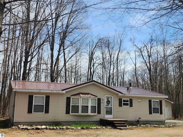 view of front facade with metal roof and crawl space