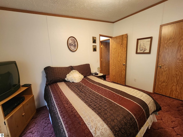 bedroom featuring carpet floors, a textured ceiling, and ornamental molding