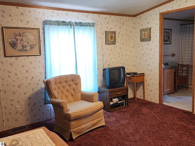 sitting room featuring carpet floors, a textured ceiling, wallpapered walls, visible vents, and ornamental molding