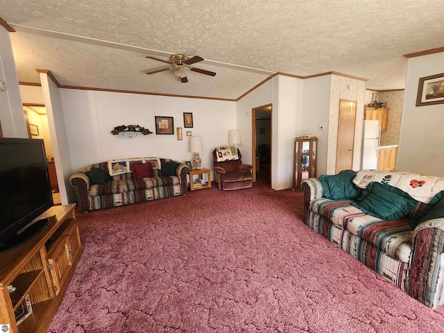 living room featuring carpet floors, ornamental molding, a ceiling fan, and a textured ceiling