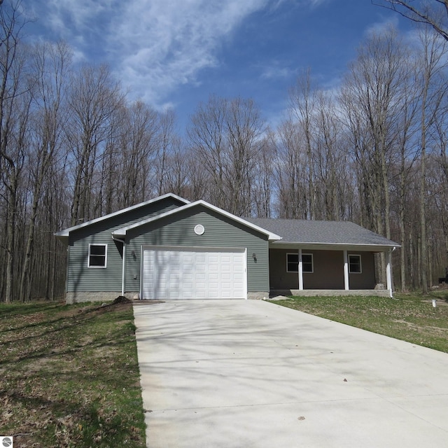 4326 Antioch Dr, Mesick, MI 49668 - single story home featuring concrete driveway, an attached garage, and a porch