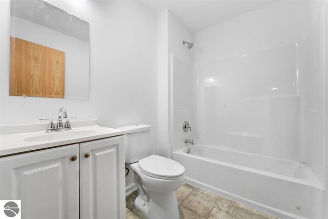4326 Antioch Dr, Mesick, MI 49668 - full bath featuring vanity, stone finish floor, bathtub / shower combination, and toilet